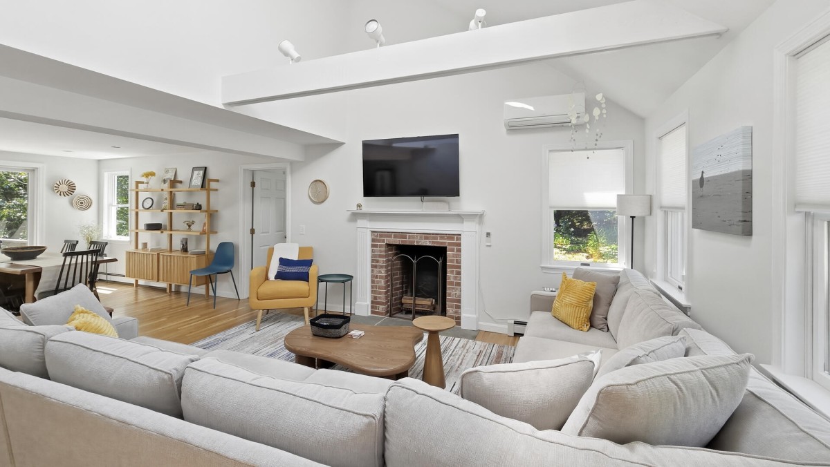 Living room has comfortable seating and a large flat screen TV